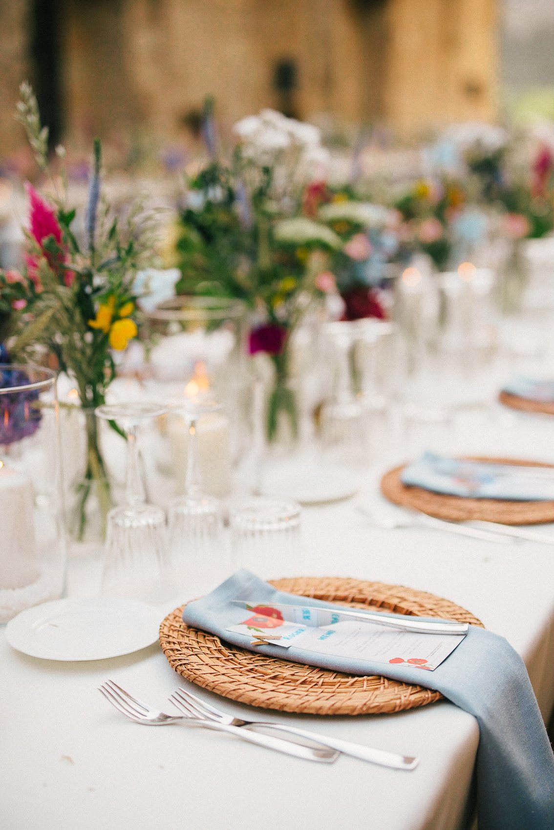 Italian wedding dinner table with flowers and glassware