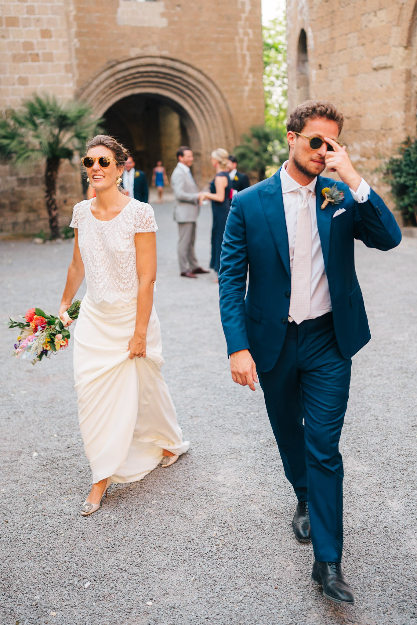 Bride and groom walking out of an Italian wedding venue