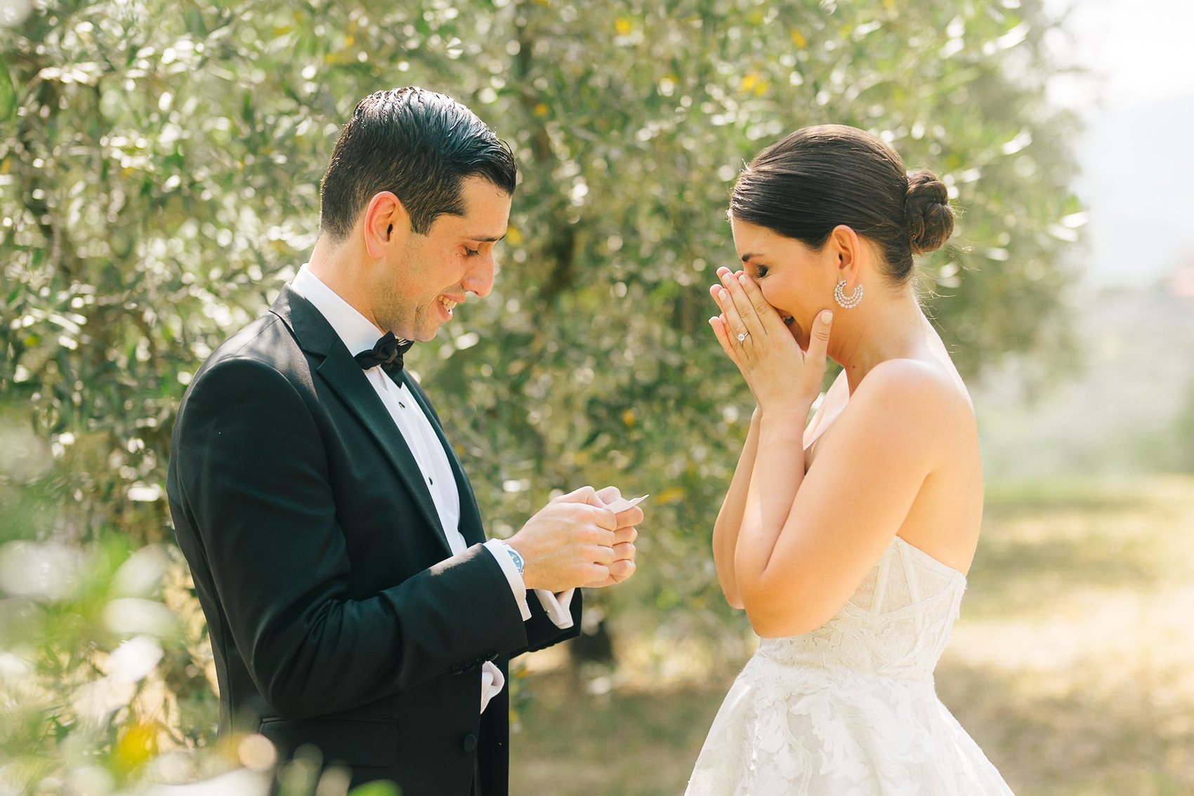 Bride covering her face during an emotional wedding moment
