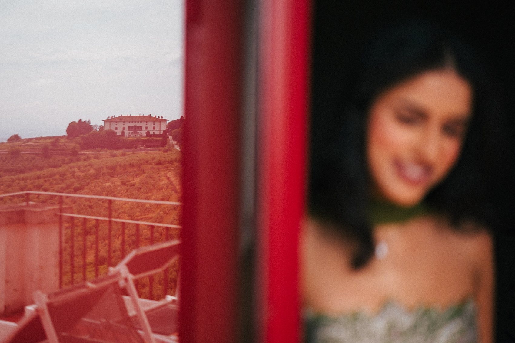 Quiet portrait through a red Italian window